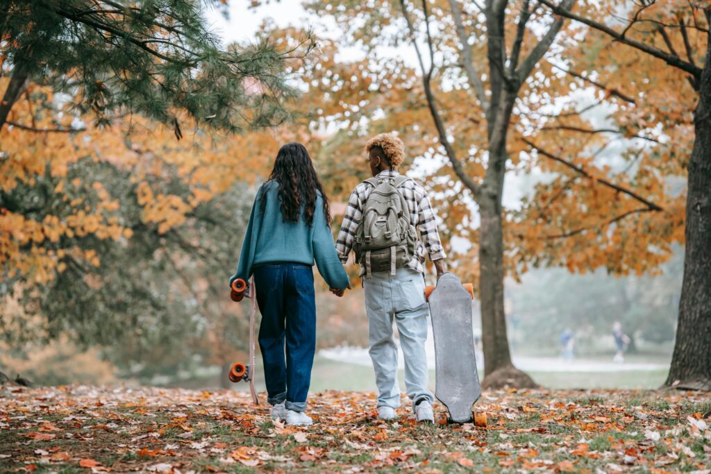 A Couple Carrying Skateboards